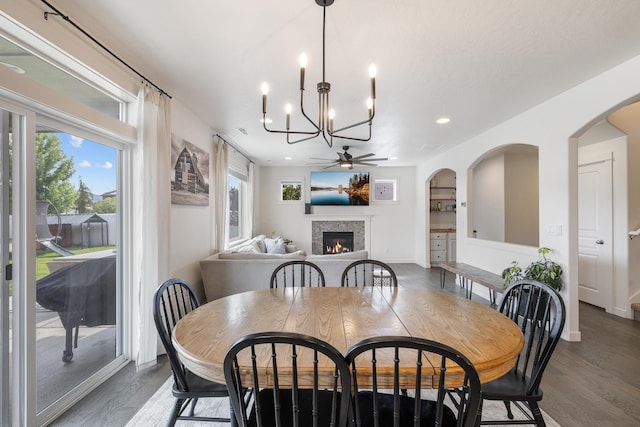 1024 W Staples Rd, Post Falls, ID 83854 - dining space with a tile fireplace, wood finished floors, a chandelier, a ceiling fan, and recessed lighting