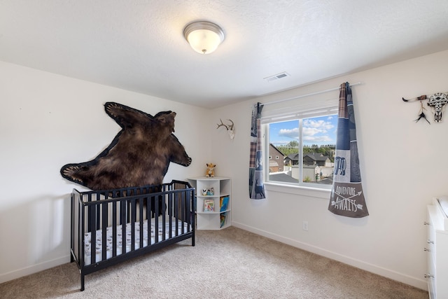 1024 W Staples Rd, Post Falls, ID 83854 - carpeted bedroom with baseboards and a crib