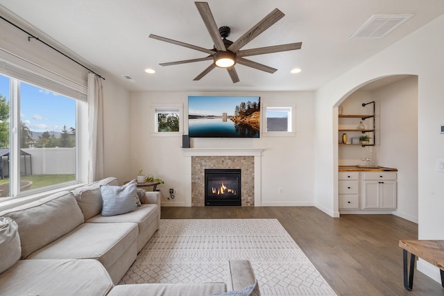 1024 W Staples Rd, Post Falls, ID 83854 - living room with wood finished floors, plenty of natural light, a ceiling fan, recessed lighting, and a tiled fireplace