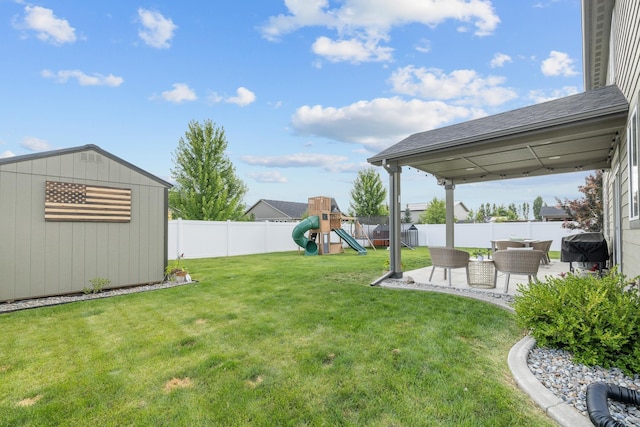 1024 W Staples Rd, Post Falls, ID 83854 - fenced backyard with a playground, a shed, and a patio area