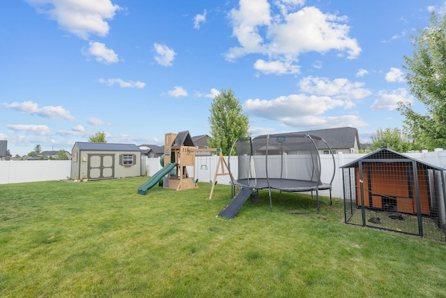 1024 W Staples Rd, Post Falls, ID 83854 - fenced backyard with a shed, a trampoline, a playground, and exterior structure