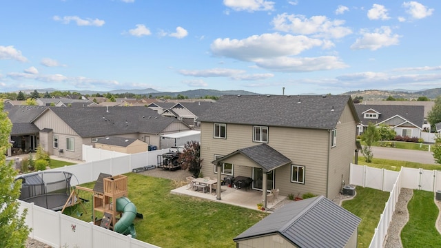 1024 W Staples Rd, Post Falls, ID 83854 - rear view of property with a residential view, a mountain view, a patio area, and a fenced backyard