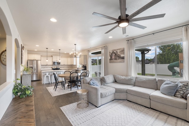 1024 W Staples Rd, Post Falls, ID 83854 - living room with ceiling fan, arched walkways, recessed lighting, a chandelier, and dark wood-type flooring