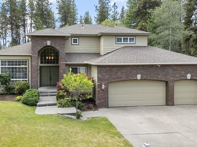 4332 S Greystone Ln, Spokane, WA 99223 - traditional-style home with brick siding, driveway, an attached garage, and a shingled roof