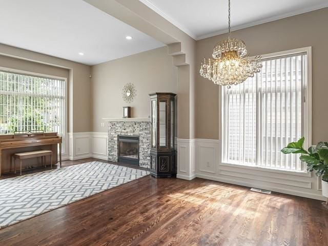 4332 S Greystone Ln, Spokane, WA 99223 - living room with a chandelier, wainscoting, ornamental molding, a fireplace, and wood finished floors