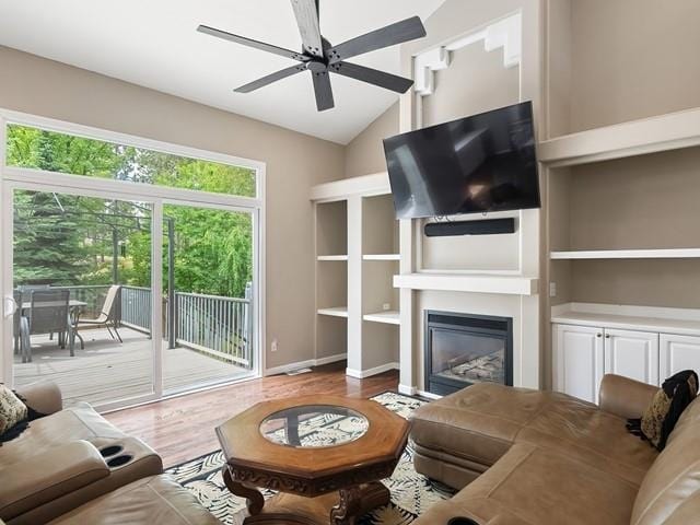 4332 S Greystone Ln, Spokane, WA 99223 - living area with ceiling fan, a glass covered fireplace, wood finished floors, and lofted ceiling