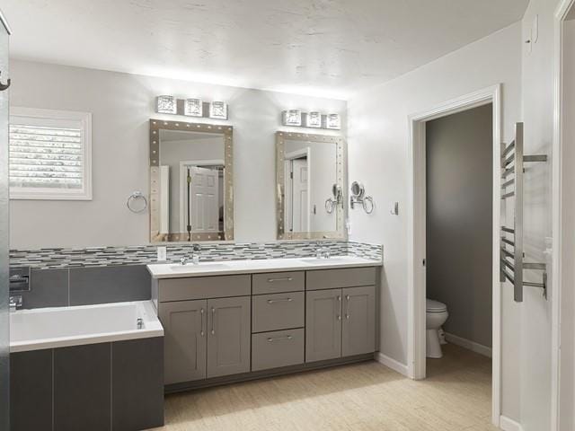 4332 S Greystone Ln, Spokane, WA 99223 - bathroom featuring double vanity, a bath, and wood finished floors