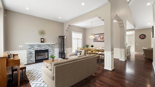 4332 S Greystone Ln, Spokane, WA 99223 - living room featuring a wainscoted wall, a stone fireplace, dark wood finished floors, recessed lighting, and a chandelier