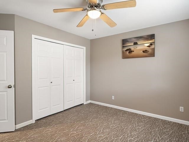 4332 S Greystone Ln, Spokane, WA 99223 - unfurnished bedroom featuring a closet, a ceiling fan, and dark carpet