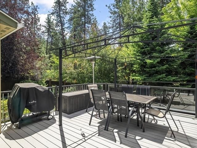 4332 S Greystone Ln, Spokane, WA 99223 - deck with outdoor dining area, grilling area, and view of scattered trees