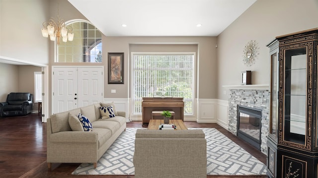 4332 S Greystone Ln, Spokane, WA 99223 - living room featuring a chandelier, a wainscoted wall, wood finished floors, a stone fireplace, and a decorative wall