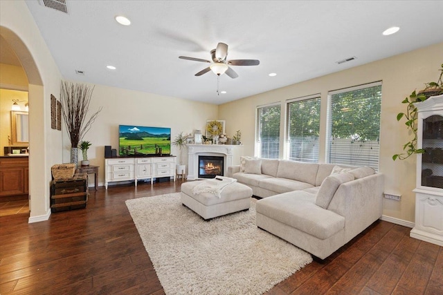 5808 N Hermosa Cir, Otis Orchards, WA 99027 - living room with dark wood-style flooring, ceiling fan, a glass covered fireplace, recessed lighting, and arched walkways