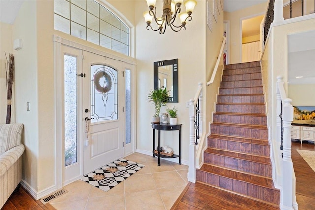5808 N Hermosa Cir, Otis Orchards, WA 99027 - tiled entryway with a chandelier, stairs, and a high ceiling