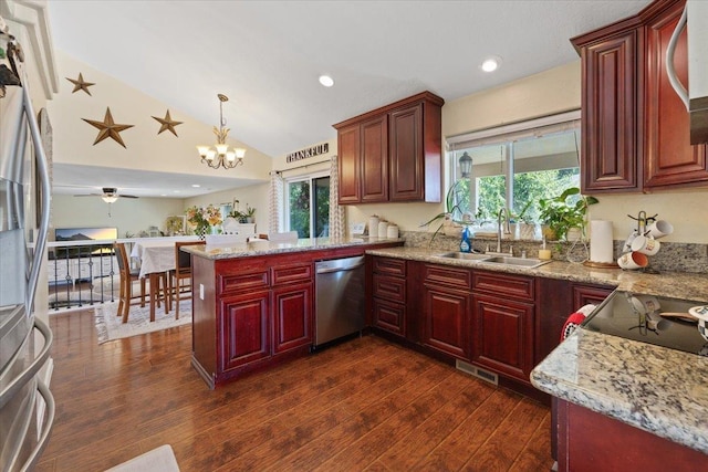 5808 N Hermosa Cir, Otis Orchards, WA 99027 - kitchen with appliances with stainless steel finishes, reddish brown cabinets, healthy amount of natural light, a peninsula, and vaulted ceiling