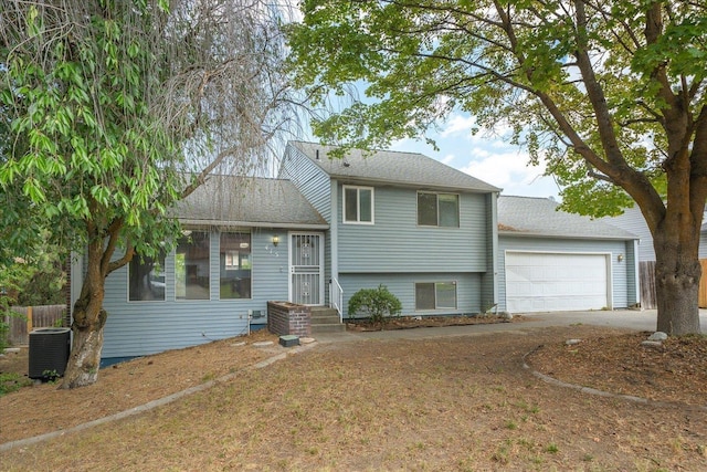 415 E Shiloh Hills Dr, Spokane, WA 99208 - split level home with a garage, driveway, and roof with shingles