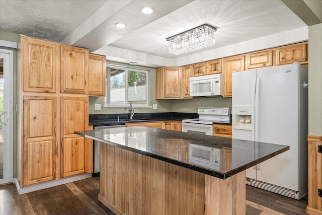 415 E Shiloh Hills Dr, Spokane, WA 99208 - kitchen with white appliances, dark wood-style floors, dark stone countertops, a center island, and recessed lighting