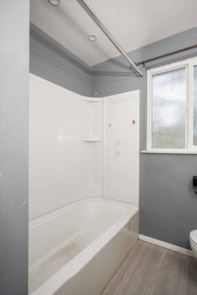 415 E Shiloh Hills Dr, Spokane, WA 99208 - bathroom featuring wood finished floors and tub / shower combination