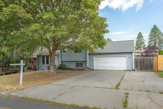 415 E Shiloh Hills Dr, Spokane, WA 99208 - tri-level home with a garage, concrete driveway, and a shingled roof