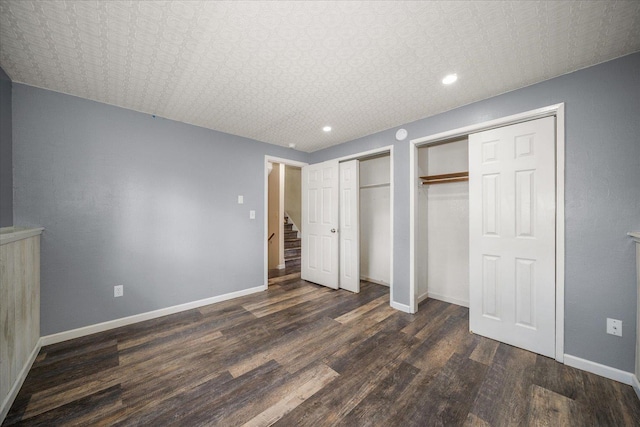 415 E Shiloh Hills Dr, Spokane, WA 99208 - unfurnished bedroom featuring multiple closets, dark wood finished floors, recessed lighting, and an ornate ceiling