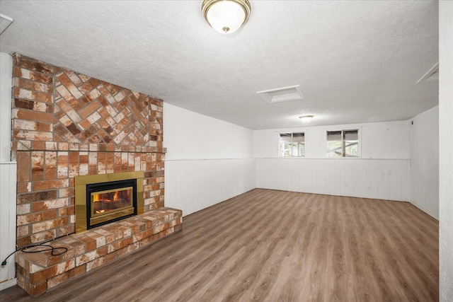 415 E Shiloh Hills Dr, Spokane, WA 99208 - below grade area with a textured ceiling, wood finished floors, and a fireplace
