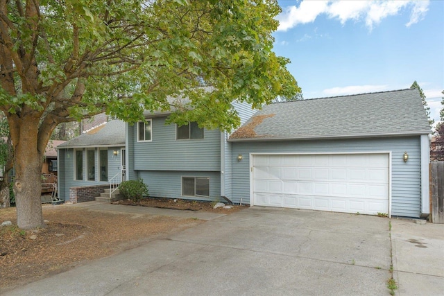 415 E Shiloh Hills Dr, Spokane, WA 99208 - split level home with concrete driveway, a garage, and a shingled roof