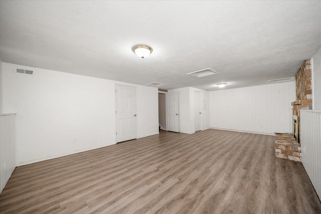 415 E Shiloh Hills Dr, Spokane, WA 99208 - basement with light wood-type flooring and a textured ceiling