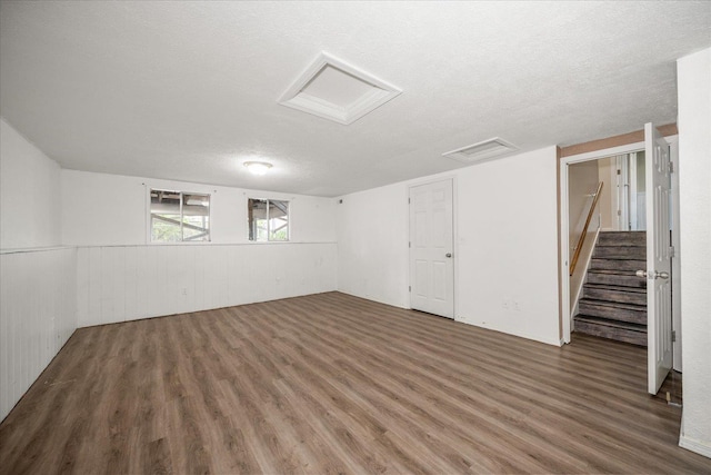 415 E Shiloh Hills Dr, Spokane, WA 99208 - below grade area featuring wood finished floors, a textured ceiling, stairway, and a wainscoted wall