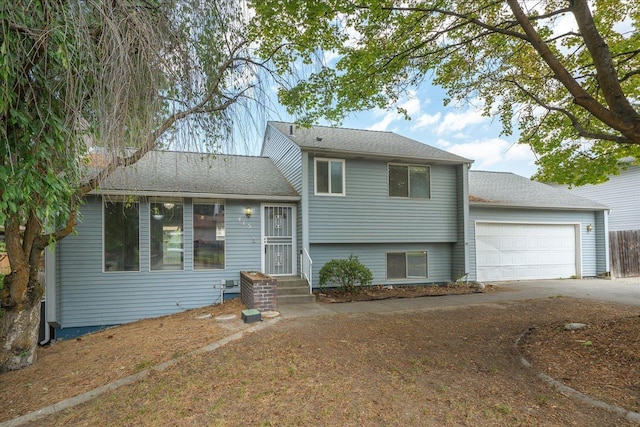 415 E Shiloh Hills Dr, Spokane, WA 99208 - split level home with a garage, concrete driveway, and roof with shingles