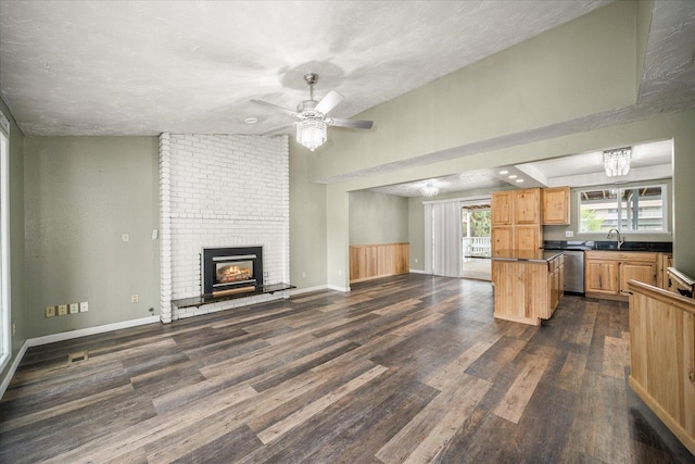 415 E Shiloh Hills Dr, Spokane, WA 99208 - unfurnished living room featuring dark wood finished floors, a fireplace, a ceiling fan, and a textured ceiling