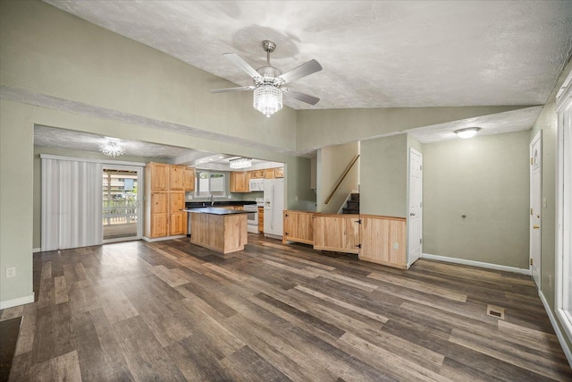 415 E Shiloh Hills Dr, Spokane, WA 99208 - kitchen with lofted ceiling, white appliances, dark countertops, dark wood finished floors, and a center island