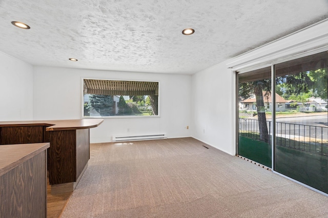 5504 N Post St, Spokane, WA 99205 - unfurnished room with a baseboard heating unit, carpet flooring, a textured ceiling, and recessed lighting