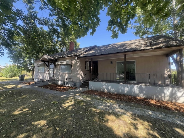 5504 N Post St, Spokane, WA 99205 - rear view of house with a chimney and covered porch