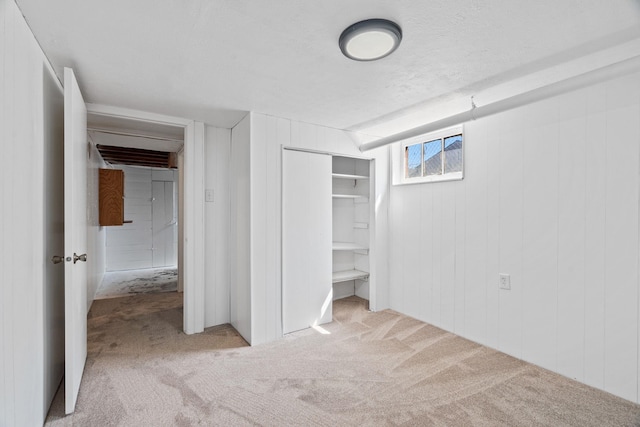 5504 N Post St, Spokane, WA 99205 - unfurnished bedroom with carpet floors, a closet, wood walls, and a textured ceiling