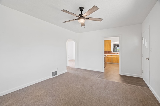 5504 N Post St, Spokane, WA 99205 - unfurnished room with carpet floors, a ceiling fan, and arched walkways