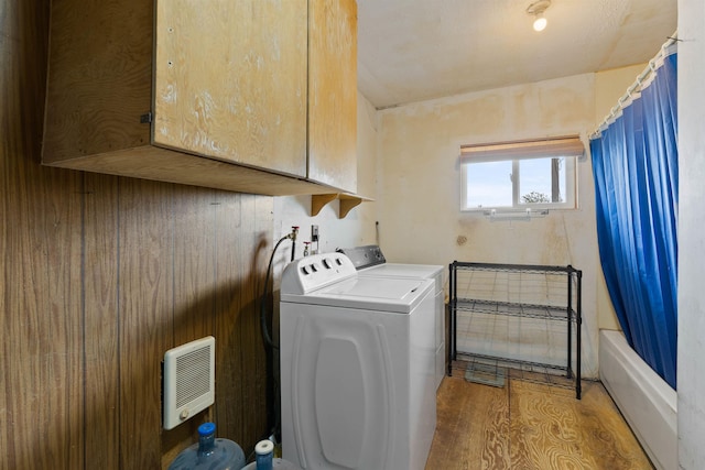 2510 N Rambo Rd, Spokane, WA 99224 - washroom featuring cabinet space, washer and dryer, and wood finished floors