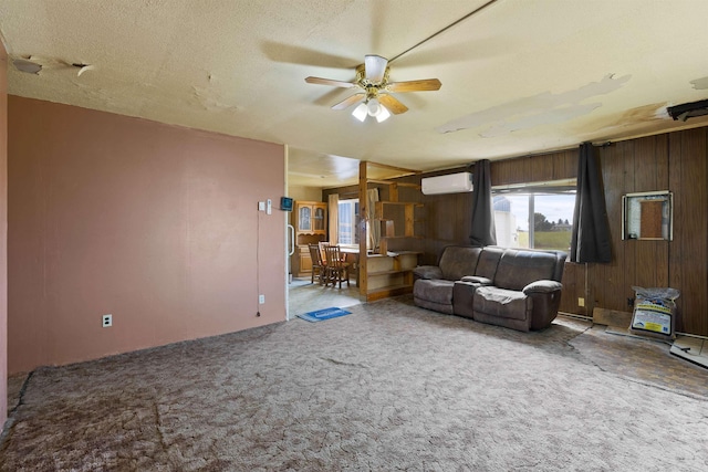 2510 N Rambo Rd, Spokane, WA 99224 - carpeted living room with ceiling fan, wood walls, and a wall mounted air conditioner