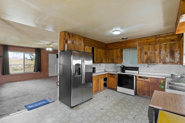 2510 N Rambo Rd, Spokane, WA 99224 - kitchen featuring stainless steel fridge, electric stove, light countertops, brown cabinetry, and a ceiling fan
