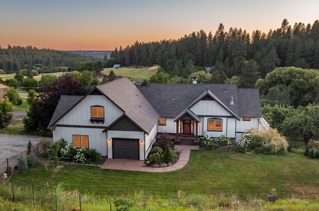 7814 S Ellis Rd, Spokane, WA 99223 - modern farmhouse style home with roof with shingles, a view of trees, and board and batten siding