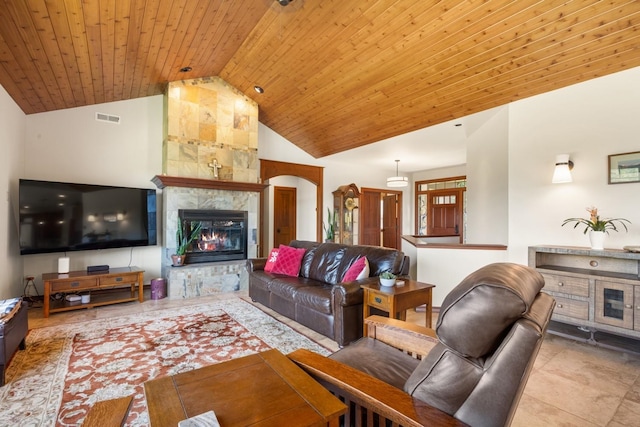 7814 S Ellis Rd, Spokane, WA 99223 - tiled living room with a tile fireplace, wooden ceiling, arched walkways, and high vaulted ceiling