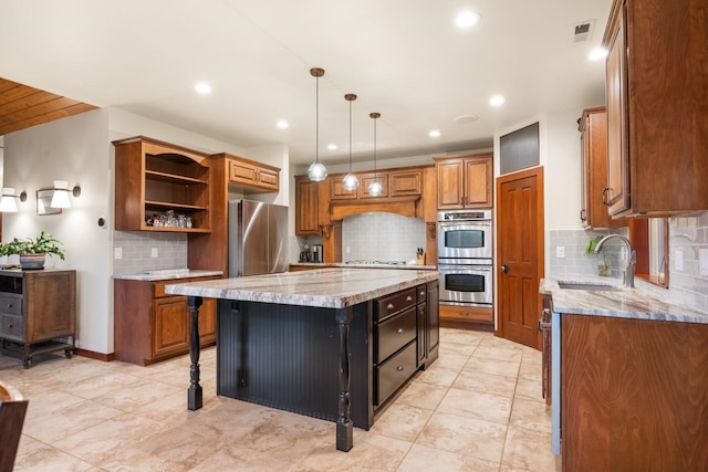 7814 S Ellis Rd, Spokane, WA 99223 - kitchen with stainless steel appliances, a kitchen island, brown cabinets, tasteful backsplash, and open shelves