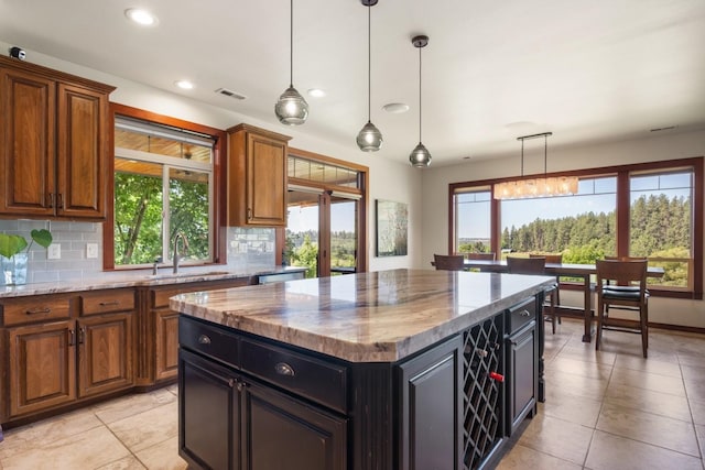 7814 S Ellis Rd, Spokane, WA 99223 - kitchen with healthy amount of natural light, light tile patterned floors, a kitchen island, and recessed lighting