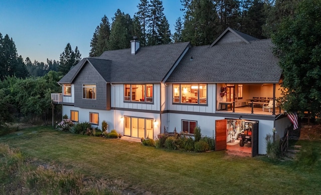 7814 S Ellis Rd, Spokane, WA 99223 - back of property featuring a lawn, a chimney, roof with shingles, and a balcony