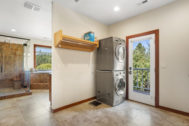 7814 S Ellis Rd, Spokane, WA 99223 - laundry room featuring estacked washer and dryer, healthy amount of natural light, recessed lighting, and light tile patterned flooring
