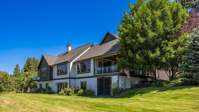 7814 S Ellis Rd, Spokane, WA 99223 - back of house featuring a lawn, a chimney, stucco siding, and a shingled roof