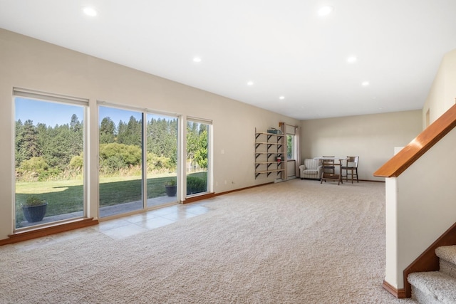 7814 S Ellis Rd, Spokane, WA 99223 - unfurnished living room featuring recessed lighting, stairway, and carpet