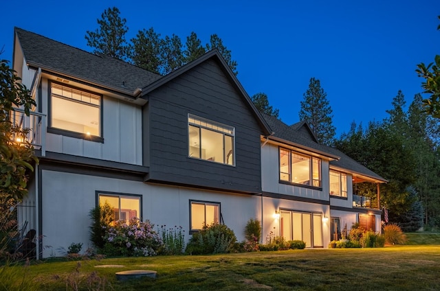 7814 S Ellis Rd, Spokane, WA 99223 - view of front of house featuring a front yard, board and batten siding, and a balcony