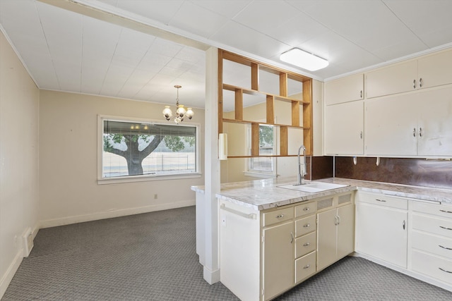 7102 E Bridgeport Ave, Spokane Valley, WA 99212 - kitchen featuring light countertops, carpet, a chandelier, and backsplash