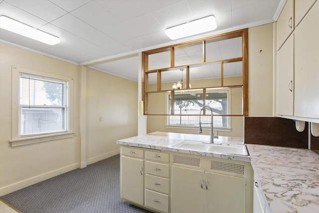 7102 E Bridgeport Ave, Spokane Valley, WA 99212 - kitchen featuring carpet floors, a chandelier, crown molding, and cream cabinetry