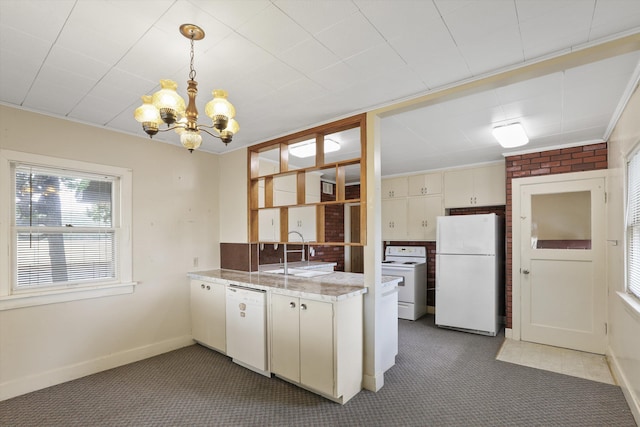 7102 E Bridgeport Ave, Spokane Valley, WA 99212 - kitchen featuring white appliances, a chandelier, carpet floors, hanging light fixtures, and a peninsula