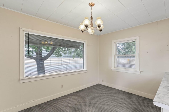 7102 E Bridgeport Ave, Spokane Valley, WA 99212 - spare room featuring a chandelier and dark colored carpet